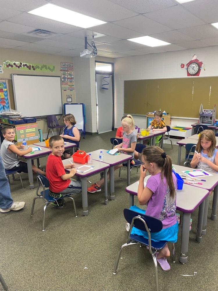 kids coloring at desks 