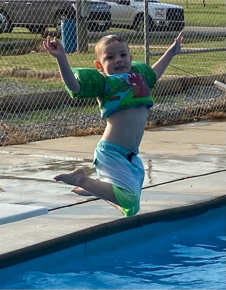 boy jumping into water 